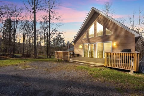 Stunning A-Frame Cabin Exterior Surrounded by Nature at Sunset