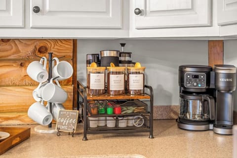 Coffee station stocked and ready—complete with mugs, a coffee maker, and essentials to help you start the day with ease.