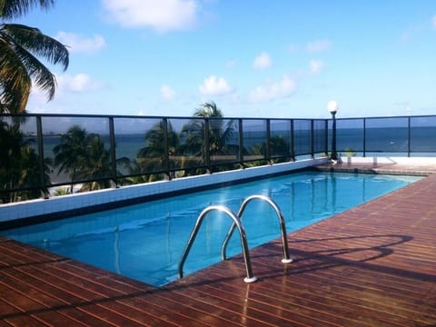 Dive into the rooftop pool with endless ocean views.