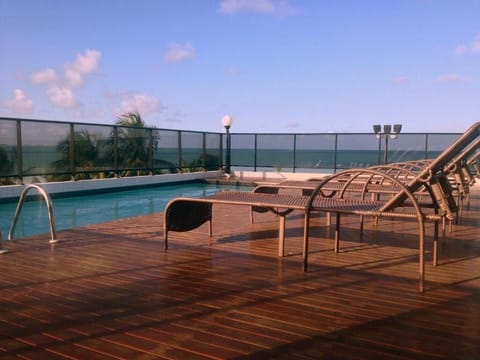 Stretch out on sun loungers beside the shimmering rooftop pool.