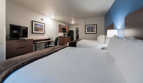 Settle in with roomy beds, workspace, and convenient in-room kitchenette.