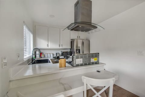 Modern kitchen with a breakfast bar, perfect for a quick meal.