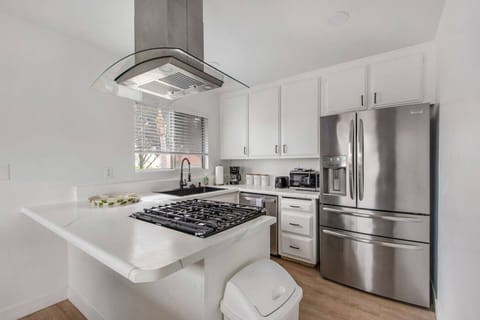 Fully stocked kitchen with cooking supplies and a drip coffee maker