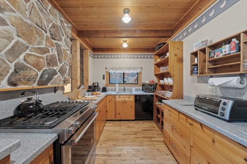 Warm, wood-finished kitchen equipped with modern appliances and everything you need for home-cooked meals.