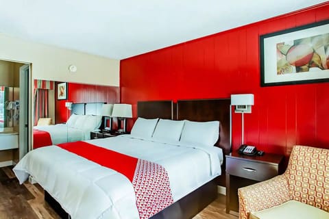 Unwind in crisp linens with bold, modern red accents.