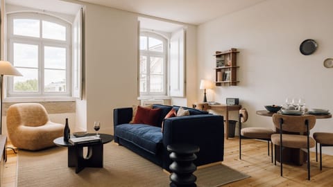 Bright living room with cozy seating, natural light, elegant decor, wooden floors, and warm, inviting ambiance. 
#LivingRoom 
#CozyHome 
#InteriorDesign 
#NaturalLight
#AndoLiving