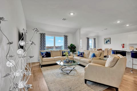 Spacious living area with open layout, comfortable seating, and Smart TV