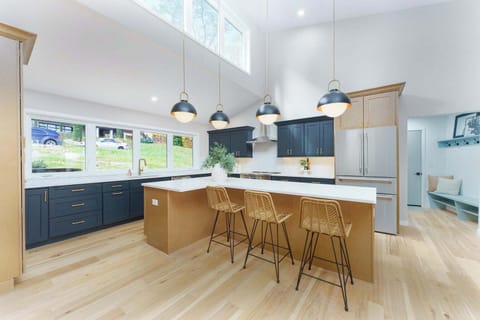 Large sunlit kitchen with Thermador appliances and island seating