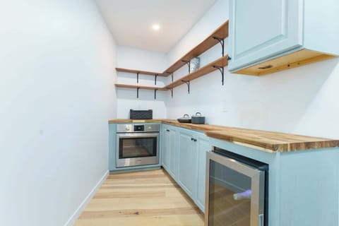 Butler's pantry adjacent to kitchen with second oven, beverage fridge, & storage