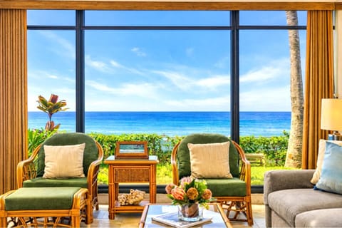 Floor-to-ceiling windows bring the ocean indoors, creating a breezy, open feel in the living space.