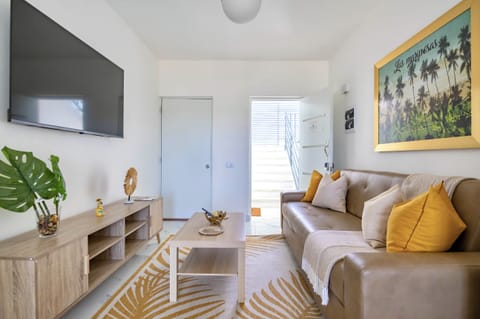 Bright living room with Smart TV, A/C, and comfortable seating