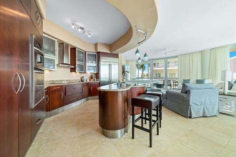 This well-designed kitchen boasts rich wood cabinetry, granite countertops, and stainless steel accents. The open layout ensures a seamless transition to the living and dining areas, creating a perfect space for gatherings.