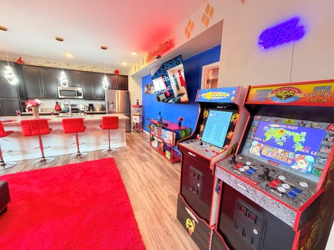 Arcade + big-screen TV corner—classic games (Pac-Man/Street Fighter) for friendly competition.