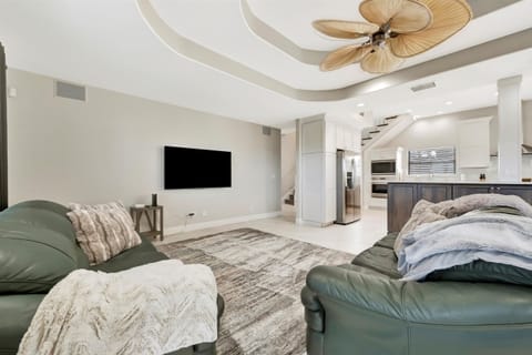 Open-Concept Living Area with Smart TV and Seamless Kitchen Flow