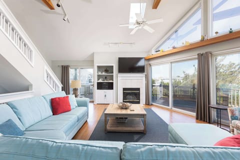 Top Level: Spacious Living Room w/ Vaulted Ceilings, Floor-to-Ceiling Windows, Fireplace, Smart TV, and Plush Sectional Seating