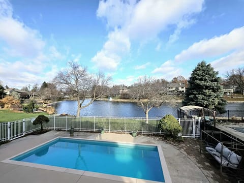 Private pool with multiple lounge areas and grill area