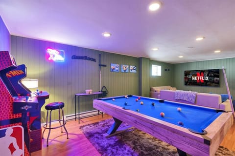 Fun for everyone! Loaded game room with pool table, foosball, arcade games, board games, and comfy seating.