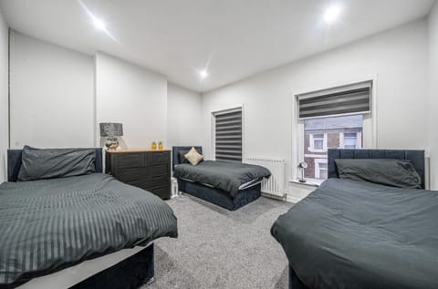 Triple bedroom with soft lighting