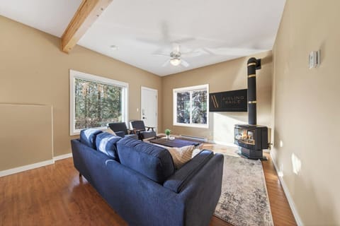 Living room with a gas-lit fireplace, smart TV, & cozy seating