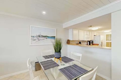 Enjoy easy meals during your beach stay in this open dining area with seamless access to the kitchen. Bright, coastal décor and a functional layout make it perfect for casual dining, morning coffee, or winding down after the beach.