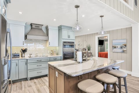 Cook and gather in this stylish island kitchen with coastal finishes and modern appliances. Designed for a relaxing beach stay, it offers plenty of space to enjoy meals and unwind after a day by the shore.