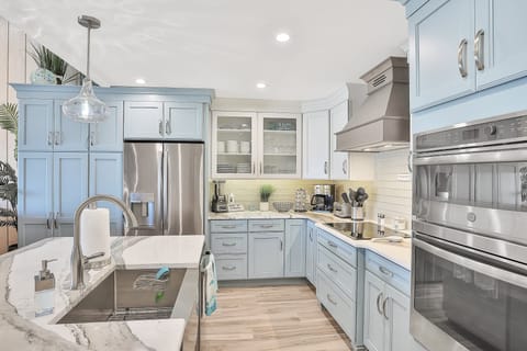 Enjoy a bright, fully equipped kitchen with coastal colors and modern appliances. Perfect for your beach stay, this stylish space makes preparing meals easy after a day of sun, sand, and seaside adventures.
