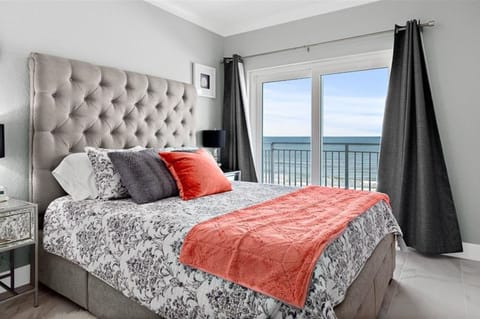 Drift off to sleep in a serene oceanview bedroom featuring a plush bed and private balcony. This relaxing beach stay offers soothing coastal views, natural light, and the perfect retreat after a day by the shore.
