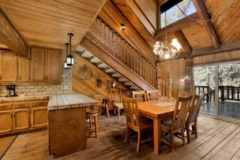 Kitchen with a refrigerator, stove, microwave, oven, toaster, coffee machine, dishwasher, and a dining table to enjoy a delicious meal.
