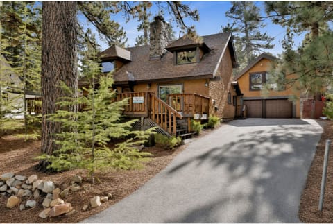 Welcoming cabin entry surrounded by towering pine trees, offering fresh mountain air and a peaceful forest setting the perfect first impression for your Big Bear Lake getaway.