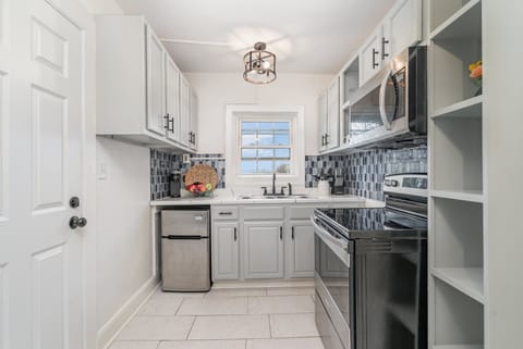 Unit 1: Essentially equipped kitchen, complete with stainless-steel appliances and a dining area for 2 guests.