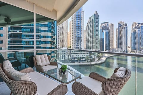 Step outside onto the balcony and enjoy the stunning canal views while relaxing in the comfortable seating area.