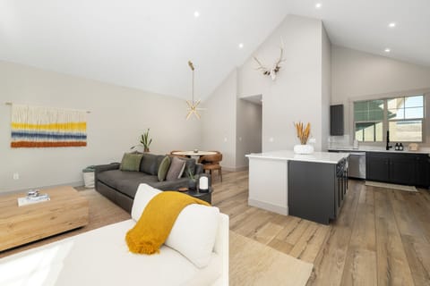 Step into your bright open-plan sanctuary where modern comfort meets warm style. Relax on the plush sofa while dinner cooks in your sleek kitchen.