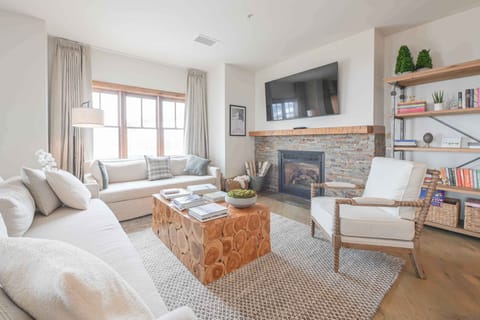A cozy living room featuring a gas fireplace, comfortable seating, and rustic decor, perfect for relaxing evenings.