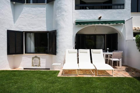 Private garden at the back of the property with 3 sun loungers and a full dining set 