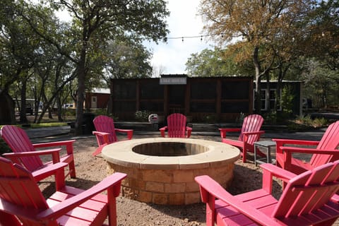 Lake House: Gather Around the Fire Pit: Enjoy evenings under the stars gathered around the beautiful stone fire pit, surrounded by bright Adirondack chairs—perfect for s'mores and sharing stories!