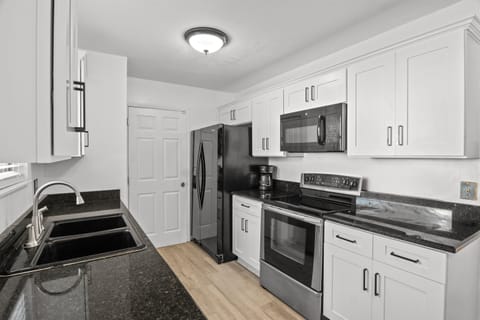 Kitchen. Refrigerator, stove, range, & microwave,