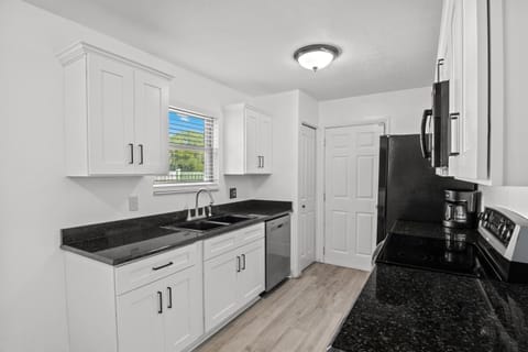 Kitchen. Sink. Door opens to the garage & laundry area.