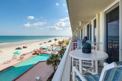 Stunning oceanfront balcony view overlooking the pool and sandy shoreline. Enjoy your beach stay with panoramic ocean views, sea breezes, and a front-row seat to beach life just steps below.