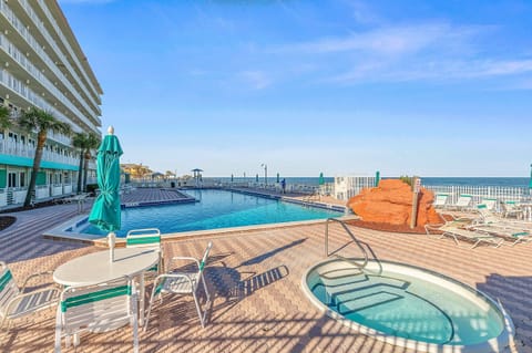 Unwind at the oceanfront pool and hot tub overlooking the beach and Atlantic waves. A standout feature of your beach stay, offering resort-style relaxation, lounge seating, and easy access to the sand and surf.
