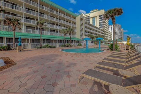 Relax at this family-friendly oceanfront splash pool, surrounded by loungers and palm trees. Perfect for soaking up the sun and enjoying unforgettable beach-stay vibes just steps from the shoreline.