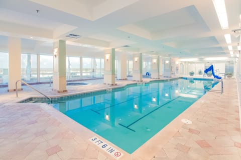 Enjoy year-round relaxation during your beach stay with this spacious indoor pool featuring ocean views, a hot tub, and plenty of deck space for unwinding after coastal adventures.
