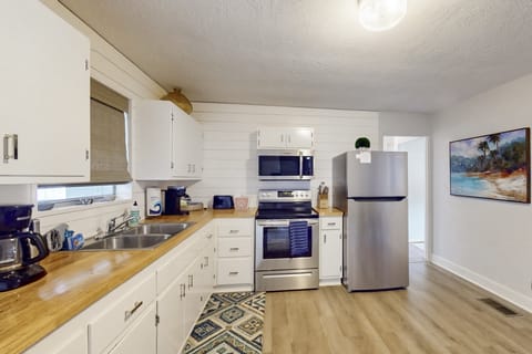 Spacious, beach-style kitchen with modern appliances, ample prep space, and coastal charm—ideal for cooking, gathering, and enjoying easy meals during your laid-back beach stay.