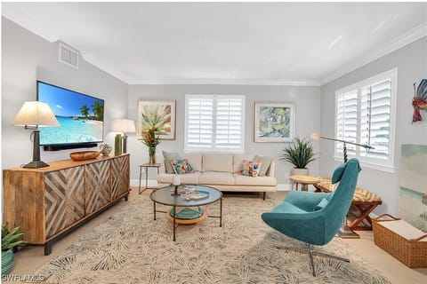 Bright and inviting living room with coastal decor, natural light, and relaxing.