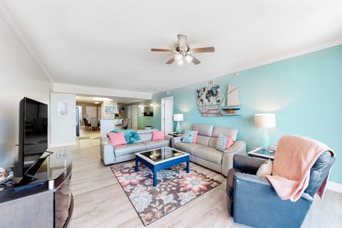 Relax in this airy, beach-style living room featuring coastal décor, comfy seating, and an open layout—perfect for unwinding after a day at the beach. Ideal for a serene seaside stay.