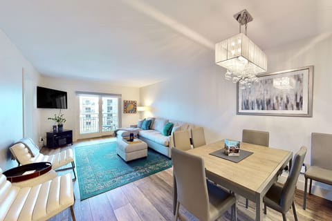 Enjoy open-concept coastal living with a comfortable lounge, stylish dining space, and balcony access. Perfect for relaxing, dining, and making memories during your beach stay near the ocean.