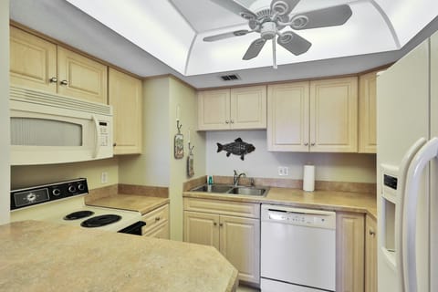 Fully equipped kitchen with coastal touches, ample counter space, and modern appliances. Perfect for preparing meals and snacks during your beach stay after sunny days by the shore.