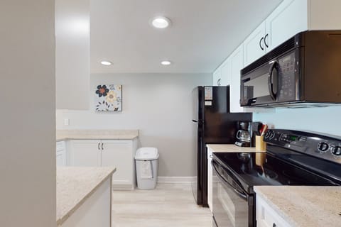 Bright, fully stocked kitchen with modern appliances and plenty of counter space—perfect for cooking meals after a fun-filled day on the beach.