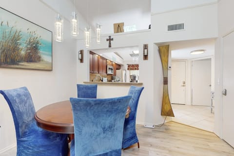 This inviting dining area features plush seating, modern lighting, and beach-inspired décor—perfect for relaxing meals during your beach stay getaway.