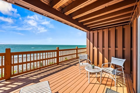 Step onto the deck and feel the Gulf breeze while chaise lounges and a table invite peaceful relaxation.