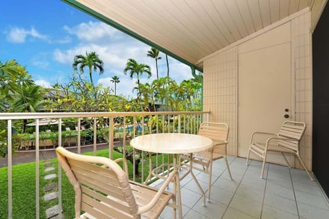 Unwind on the private balcony surrounded by swaying palms and vibrant greenery — the perfect spot for morning coffee or sunset chats